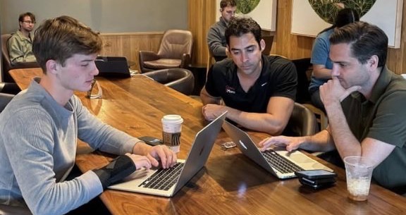 The Full Wave Development team meeting with a local business